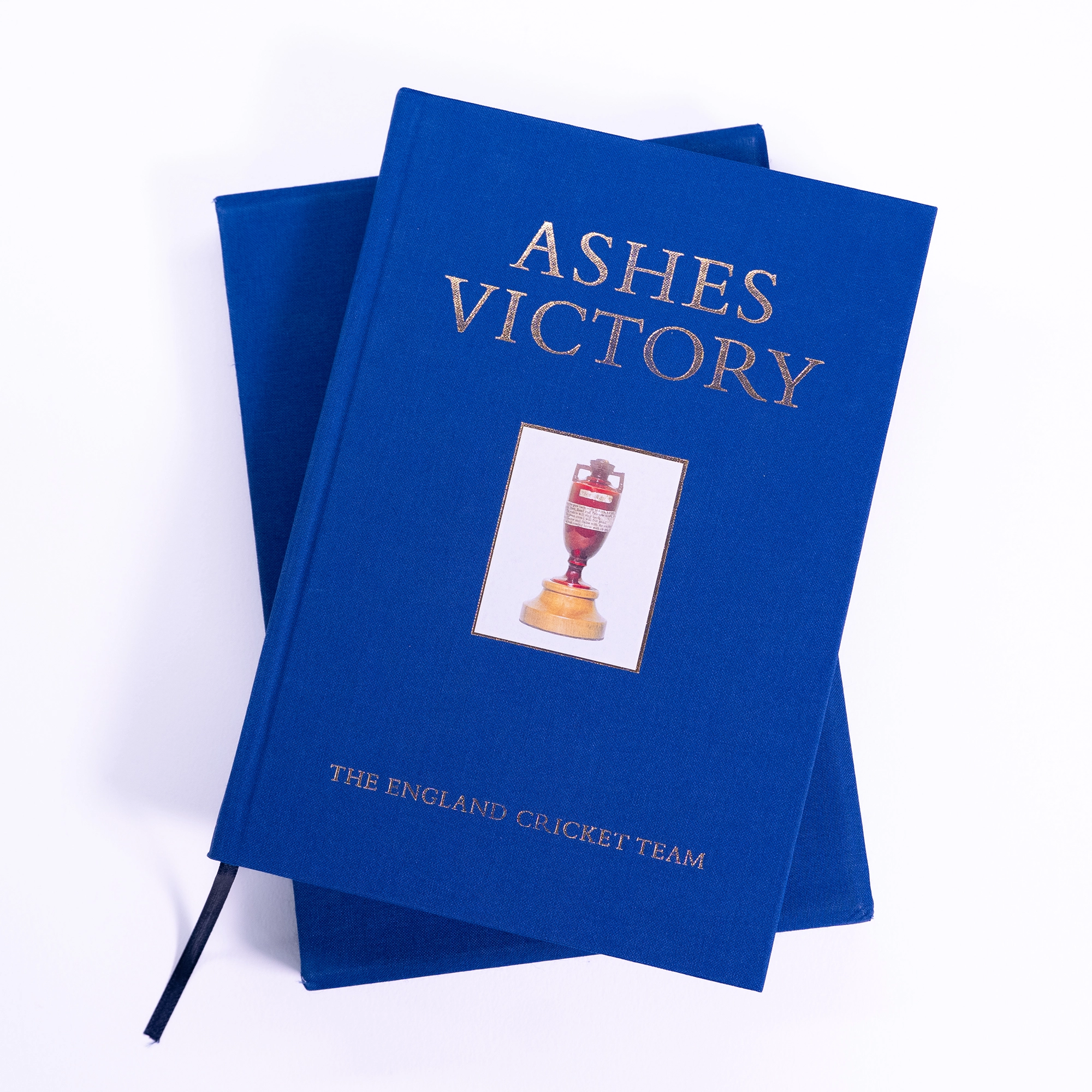 the blue clothbound edition of Ashes Victory lies on top of the slipcase